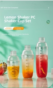 Three clear PC cocktail shakers with scales and colorful drinks on mint green background