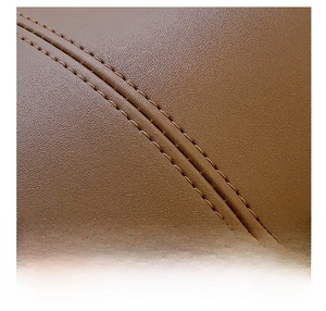 Macro detail of dark brown litchi grain leather texture and precise double stitching