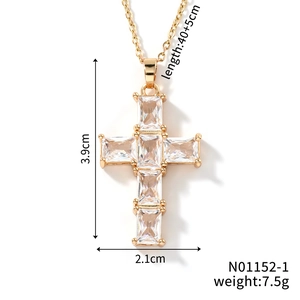 Macro detail of gold cross pendant with cubic zirconia inlay and precise dimensions