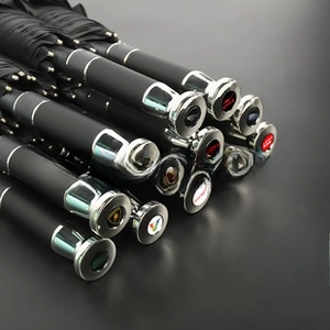 Detail view of automatic umbrella handles with various custom logo caps and silver metal rings