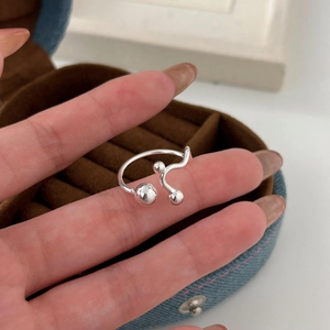 Close-up of minimalist S925 sterling silver ring with polished bead design in a jewelry box