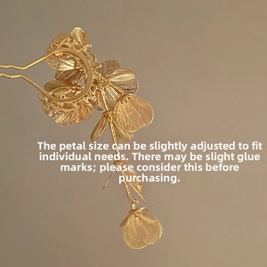 Detail view of gold floral hairpin with adjustable petals and brushed metal texture