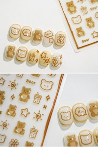Detail of 3D bear and flower gold stamping nail stickers with caramel brown finish