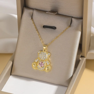 Golden teddy bear pendant necklace with white zircons and pink heart stone
