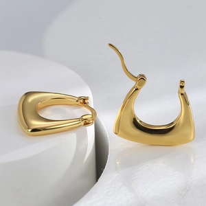 Minimalist S925 sterling silver U-shaped gold earrings on a clean geometric base