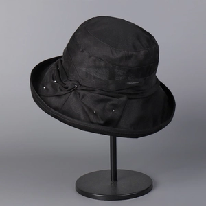 Close-up of black Lyocell linen sun hat featuring a side bow and white bead accents