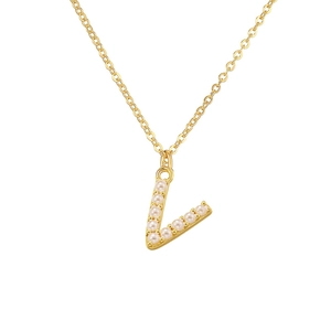 Macro shot of gold V-letter pendant with inlaid white pearls on polished chain