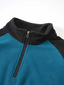 Detail of blue and black fleece pullover showing the half-zip stand collar and stitching