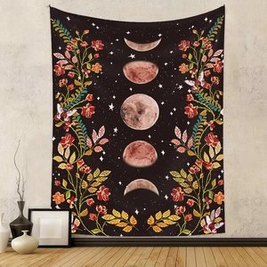 Bohemian black tapestry featuring moon phases and vintage floral butterflies on a grey wall