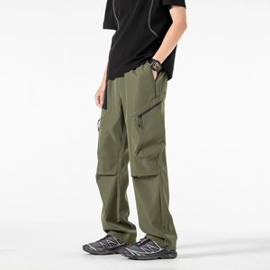 Men's olive green cargo pants with a loose fit, functional zip pockets, and high-waist design