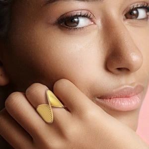 18k gold plated stainless steel twisted wavy ring with textured finish on hand