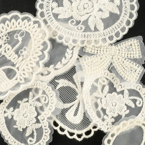 White floral butterfly embroidery lace patches for DIY hair accessories on black background