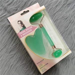 Green jade facial roller and gua sha set with massage tools in premium packaging