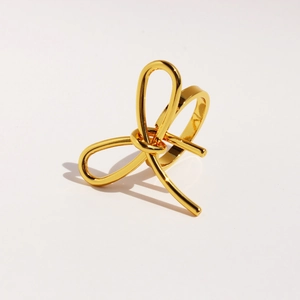 Modern gold metallic bow knot ring for women with polished finish on white background