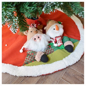 Detail of Christmas tree skirt featuring plush Santa and Snowman with faux fur trim