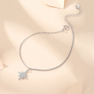 Sparkling S925 sterling silver star bracelet with adjustable chain on warm background
