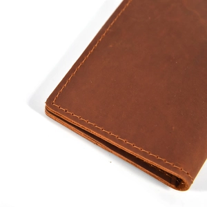 Detailed close-up of handmade stitching on brown vintage crazy horse leather wallet