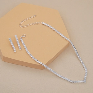 Detail of silver V-shaped necklace and square zircon earrings on display stand