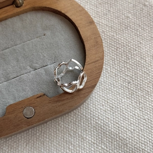 Detailed macro view of S925 sterling silver hollow heart cuff resting on a velvet lining