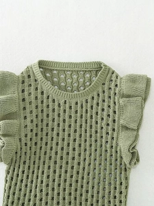 Detailed view of green knitted top with hollow mesh patterns and ruffle cap sleeves