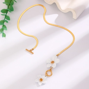 Detail of white double-layer flower pendant on golden snake chain with T-bar toggle clasp