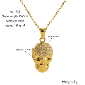 Macro view of 18k gold plated stainless steel skull pendant with rhinestone setting