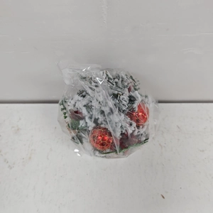 Detail of mini artificial Christmas tree with red golden ball and faux snow covering