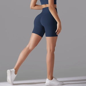Detail of high waisted navy blue seamless yoga shorts showing the butt lifting texture