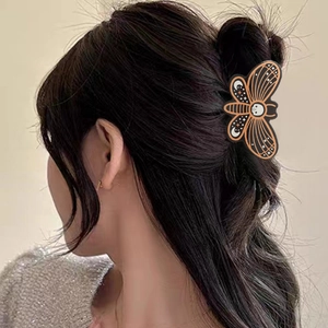 Halloween pumpkin shark clip with bat and skeleton patterns shown on woman hairstyle