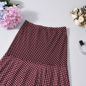 Detail of burgundy wine skirt with white polka dots featuring lightweight chiffon fabric