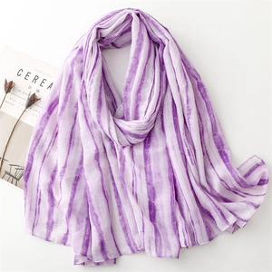Detail of purple gradient scarf with gold foil accents and delicate fringe edges