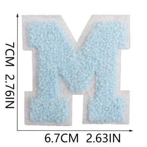 Macro detail of blue towel embroidery letter M patch with precise size measurements