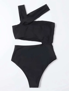 Flat lay of black one-shoulder swimsuit featuring waist cut-out and strap details