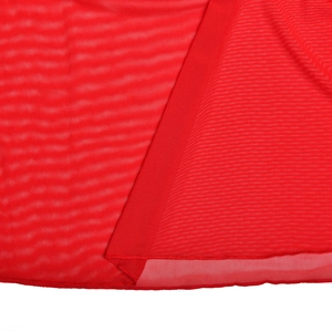 Macro shot of red sheer mesh fabric showing detailed texture and breathable weave
