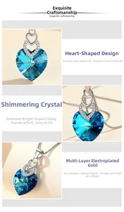 Detailed close-up of blue heart-shaped crystal pendant with dual heart diamond inlay