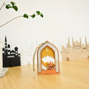 Wooden Eid Mubarak arch ornament with mosque and camel silhouette on a wooden table