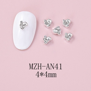 Detail of silver starfish nail charms with rhinestones on pink background 4x4mm