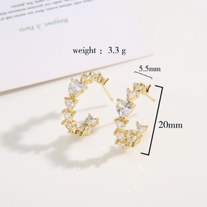 Gold C-shape earrings with sparkling heart zircon inlays shown in elegant 20mm profile