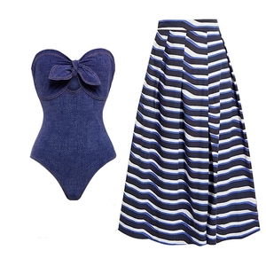 Flat lay of denim bandeau top with bow and matching striped pleated maxi skirt set