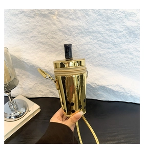Detail of creative golden bubble tea cup crossbody bag with shiny laser surface and strap