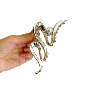 French style silver metal hair claw clip with pearl detail and minimalist twist design