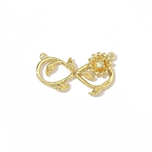 Close-up of golden infinity rose charm with yellow zircon stone for jewelry making