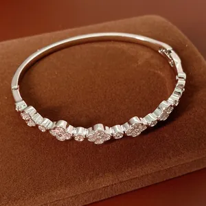 Elegant silver four-leaf clover bracelet with pink and white cubic zirconia stones