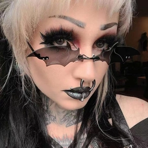 Gothic bat-wing shaped rimless sunglasses with black tinted lenses and metal accents