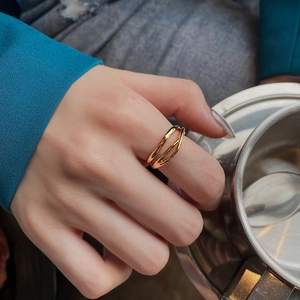 Elegant gold multi-layer intertwined open ring for women on a model's finger