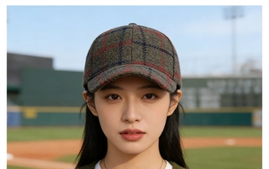 Close-up of winter wool plaid baseball cap with red and blue checkered pattern texture