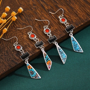 Detailed shot of bohemian floral earrings with turquoise beads and antique silver finish