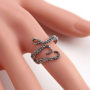 Detail of vintage octopus tentacle ring showing realistic suction cup textures and oxidation