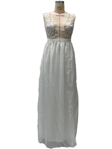 Detail view of the intricate white lace embroidery and deep V-neckline of this evening gown