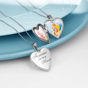 Macro view of open and closed heart locket showing 'Forever in my Heart' engraving and photo slots